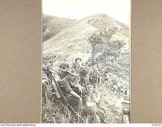 1944-03-24. SWITCHBOARD TRAIL. AUSTRALIAN TROOPS CLIMBING A SLOPE IN THE FINISTERRE RANGES ON THE WAY TO CAMERON'S KNOLL. THIS ROUTE INVOLVES A CLIMB OF 3,000 FEET