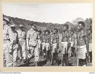 NADZAB AREA, NEW GUINEA, 1945-06-27. HIS ROYAL HIGHNESS, THE DUKE OF GLOUCESTER, GOVERNOR GENERAL OF AUSTRALIA (3) WITH LT-COL J.C. MULLALY (1) AND LT-COL T.F.B. MACADIE (2) INSPECTING A COMPANY, ..