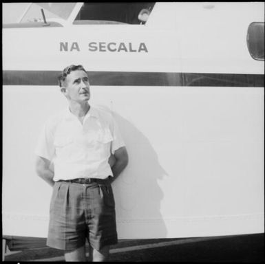 Captain Hillard standing in front of Air Pacific's Grumman G-73 Mallard (c/n J-13) amphibious aeroplane, Na Secala, VQ-FBC, at Nadi Airport, Fiji, November 1969 / Michael Terry