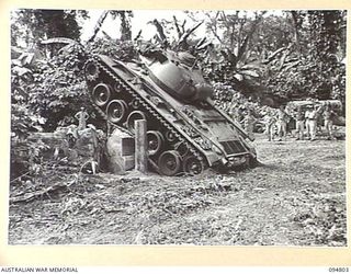 TOROKINA AREA, BOUGAINVILLE, 1945-08-08. AN M24 GENERAL CHAFFEE LIGHT TANK FAILING IN AN ATTEMPT TO CLIMB OVER TWO LOGS AT A HEIGHT OF THREE FEET FIVE INCHES, DURING TRIALS CONDUCTED FOR THE WAR ..