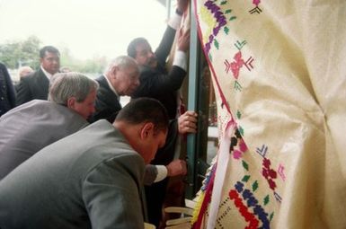 King Taufa'ahau Tupou IV, King of Tonga, entering church Vaine Mo'onia through a portal of fine mats