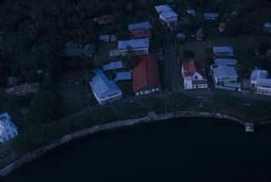 [Aerial view of dwellings and coastline in American Samoa]