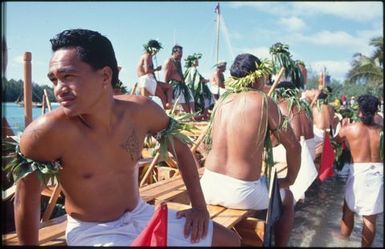 Group of men wearing white lava lava on boat