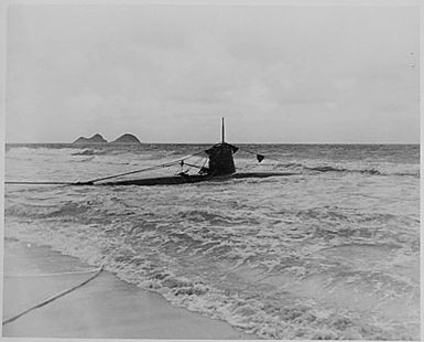 Naval photograph documenting the Japanese attack on Pearl Harbor, Hawaii which initiated US participation in World War II. Navy's caption: Beached two-man Japanese submarine at Bellows Field Hawaii, after the attack on Pearl Harbor of Dec. 7, 1941.