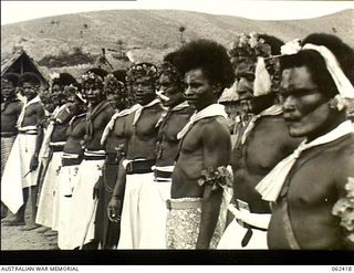 Kila Kila, New Guinea. 1943-12-25. Natives of the Mekeo tribe waiting for their turn to perform a traditional tribal dance at the Christmas celebrations at the Australian and New Guinea ..