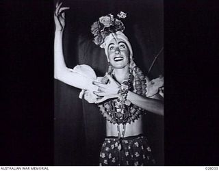 PAPUA, NEW GUINEA, 1942-07. AUSTRALIAN AND AMERICAN TROOPS IN NEW GUINEA ARE NOW ENTERTAINED BY A THEATRICAL COMPANY FORMED FROM AMONG THE PERSONNEL OF AN AUSTRALIAN INFANTRY BRIGADE. HERE IS SHOWN ..
