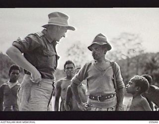 NEW GUINEA. 1943-07-28. NX12227 BRIGADIER D. N. VERON OBE, CHIEF SIGNALS OFFICER, NEW GUINEA FORCE (1), TALKING WITH NATIVES ON THE BANKS OF THE WARIA RIVER