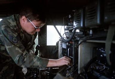 A forward air controller operates a radio used to direct an F-4 Phantom II aircraft a bomb target. The controller is from the 22nd Tactical Air Support Squadron and is involved in Exercise Opportune Journey 4