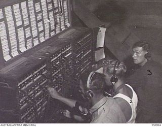 PORT MORESBY, NEW GUINEA. 1943-07-14. SWITCHROOM AT HEADQUARTERS, NEW GUINEA LINES OF COMMUNICATION, SIGNALS, AIF, LEFT TO RIGHT: N318624 SIGNALMAN G. H. ROBERTS; NX116007 LANCE CORPORAL A. C. ..