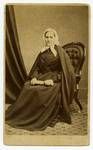 Studio portrait of an unidentified woman, sitting in chair