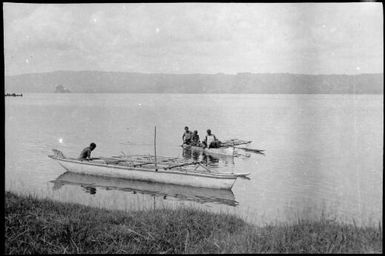 Empty outrigger canoe by the shore and a laden outrigger approaching, Rabaul, New Guinea, ca. 1929 / Sarah Chinnery