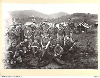 ULEBILUM, NEW GUINEA, 1945-07-11. TROOPS OF A COMPANY, 2/5 INFANTRY BATTALION, ALONGSIDE A 4.2-INCH MORTAR AND WEAPON PIT. THE MEN ARE ON HIGHER RIDGES WEST OF THE KULAURU MISSION AND THE WEAPON IS ..