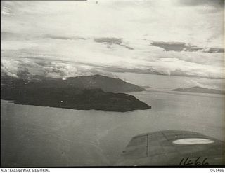 D'ENTRECASTEAUX ISLANDS, PAPUA. C. 1944-02. AERIAL VIEW OF FERGUSON ISLAND, NORTH EAST OF NEW GUINEA, AS SEEN FROM A BEAUFORT BOMBER AIRCRAFT OF NO. 8 SQUADRON RAAF ON PATROL