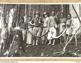 WAU AREA, NEW GUINEA, 1943-08-15. NG2126 WARRANT OFFICER 2 J. MCGRATH (LEFT) AND NG2157 CORPORAL E. N. FORSYTH (RIGHT), BOTH OF THE AUSTRALIAN AND NEW GUINEA ADMINISTRATION UNIT, PHOTOGRAPHED WITH ..