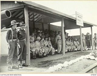 LAE, NEW GUINEA, 1944-03-08. OFFICIAL GUESTS FROM HEADQUARTERS, LAE BASE SUB AREA, THE 2/7TH AUSTRALIAN GENERAL HOSPITAL, UNITED STATES FORCES, AND THE ROYAL AUSTRALIAN AIR FORCE, WATCH VX20308 ..