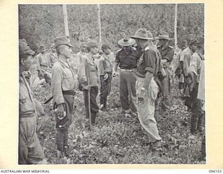 MUSCHU ISLAND, NEW GUINEA. 1945-09-10. MEDICAL OFFICERS OF 6 DIVISION, ACCOMPANIED BY THE JAPANESE COMMANDER, WALKING THROUGH THE JAPANESE RANKS, LOOKING OUT FOR ANY CONSPICUOUS CASES OF DISEASE ..