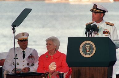 Admiral Charles R. Larson, Commander in CHIEF, US Pacific Command, speaks at the Kilo 8 Pier during the observance of the 50th anniversary of the Japanese attack on Pearl Harbor. General Colin L. Powell, Chairman of the Joint Chiefs of STAFF, and First lady Barbara Bush are seated behind him