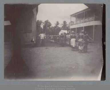 Photograph of a procession of Samoans walking to the convent in Apia, Samoa