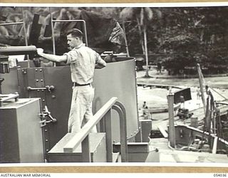 KWIARA, CHINA STRAITS, 1943-07-03. CREW MEMBERS OF THE AB-20, OF THE 1ST AUSTRALIAN WATER TRANSPORT GROUP (SMALL CRAFT), PREPARE THE GUNS FOR A TRIP UP THE COAST