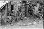 Men and boys in front of a house