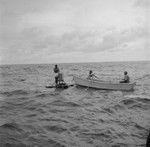 Willard Bascom on instrument raft, John D. Isaacs and unidentified man in skiff, Bikini Atoll
