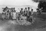 Polynesian women making a peue (mat) and a hat, Maupiti island