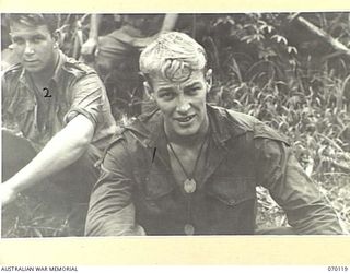 RAMU VALLEY, NEW GUINEA. 1944-01-29. N426064 PRIVATE R.M. WILLIAMS (1) A MEMBER OF THE MORTAR PLATOON OF THE 57/60TH INFANTRY BATTALION AND PRIVATE V. CHAFFEY (2) ACT AS "KAI" (FOOD) CARRIERS IN ..