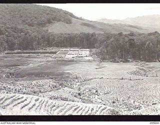 AIYURA, NEW GUINEA, 1946-01-09. A SECTION OF THE AUSTRALIAN NEW GUINEA ADMINISTRATIVE UNIT EXPERIMENTAL STATION SHOWING FLAT CONTOURS AND THE QUININE PLANT NURSERY IN BACKGROUND