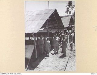 MUSCHU ISLAND, NEW GUINEA. 1945-09-24. MAJOR GENERAL H.C.H. ROBERTSON, GENERAL OFFICER COMMANDING 6 DIVISION, ON A VISIT TO THE ISLAND INSPECTED THE CAMP, THE HOSPITAL AND ALL TROOPS. HE IS SHOWN ..