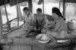 Fefiloi Muti and her parents, Uili and Tupele in the cook-house