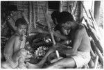 Men pounding taro and coconut pudding