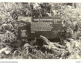 FINSCHHAFEN AREA, NEW GUINEA, 1944-03-17. ONE OF MANY BATTLE SIGNS IN THE FINSCHHAFEN AREA, THIS SIGN RECORDS THE ACTIVITIES OF TANKS ASSISTING "A" COMPASNY, 2/48TH INFANTRY BATTALION