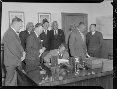 Honourable L Nu'u, Western Samoa, signs visitors book at Parliament, Wellington