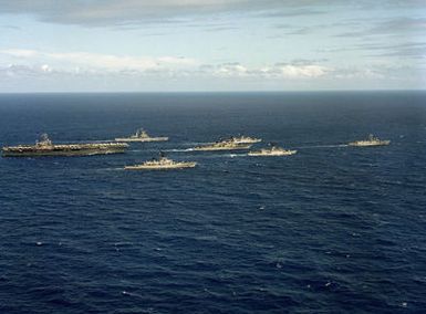 A starboard beam view of the nuclear-powered aircraft carrier USS CARL VINSON (CVN 70) underway near Hawaii with its battle group. Left to right: USS TEXAS (CGN 39), USS WORDEN (CG 18), USS HEWITT (DD 966), USS BARBEY (FF 1088), USS COOK (FF 1083), and USS SIDES (FFG 14) to be commissioned on April 14, 1985