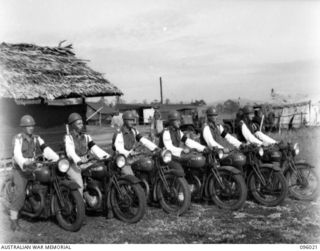 CAPE WOM, WEWAK AREA, NEW GUINEA. 1945-09-05. MEMBERS OF THE MOTOR CYCLE SECTION, 6 DIVISION PROVOST COMPANY, LINED UP BEFORE LEAVING HEADQUARTERS FOR THEIR RESPECTIVE DUTIES