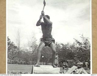 ELA BEACH, NEW GUINEA. 1943-11-13. N161748 SAPPER G. E. GEE OF THE 14TH AUSTRALIAN FIELD COMPANY, ROYAL AUSTRALIAN ENGINEERS COMPETING IN THE WOOD CHOPPING EVENT AT THE COMBINED SPORTS MEETING