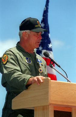 GEN John G. Lorber, Commander, Pacific Air Forces, dressed in flight suit and wearing unit baseball cap, speaks at his retirement ceremony