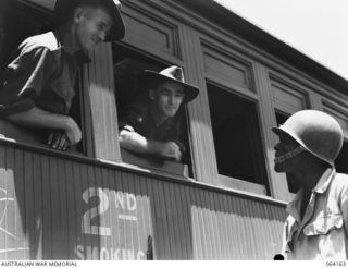 TOWNSVILLE, QUEENSLAND, AUSTRALIA. 1944-01-28. WX19840 PRIVATE M. HERBERT (LEFT) AND WX5348 CORPORAL A.W. GALLOWAY (RIGHT) OF THE 2/28TH INFANTRY BATTALION, WHO HAVE JUST RETURNED HOME FROM NEW ..