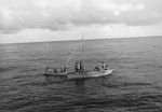 Skiff and native boat meet off Keppel Island