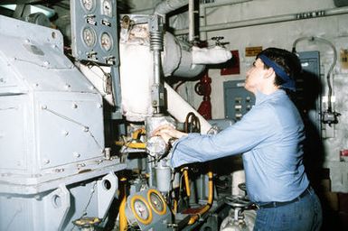 A sailor monitors the pressure gauges on one of the boilers aboard the amphibious assault ship USS SAIPAN (LHA-2). The SAIPAN steamed at flank speed for a week to be on station off the coast of Liberia for Operation Sharp Edge