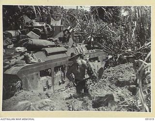 BOUGAINVILLE. 1945-04-16. TROOPER R.W. BROWN (1), AND TROOPER L.M. O'SULLIVAN (2), B SQUADRON, 2/4 ARMOURED REGIMENT PERSONNEL DIGGING IN FOR THE NIGHT AS A PROTECTION AGAINST JAPANESE ARTILLERY. ..