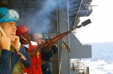 Gunners Mate SEAMAN (GMSN) Franklin of Tampa, Florida, fires a modified M14 during an underway replenishment (UR) on board the USS SAIPAN (LHA 2), in the Mediterranean