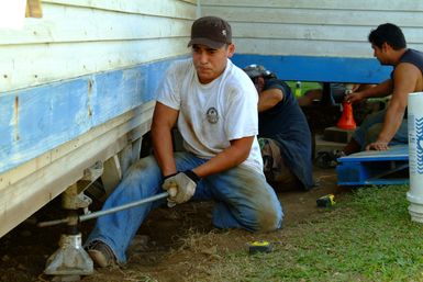 [Earthquake] Honokaa, HI, October 24, 2006 -- Recent earthquakes moved this house two feet. The New Hope Christian Fellowship uses jacks to raise and relocate the displaced home. Adam DuBrowa/FEMA.