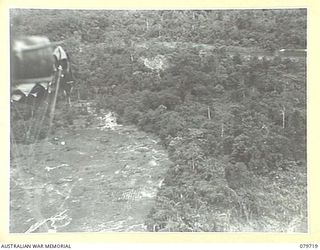 BOUGAINVILLE, SOLOMON ISLANDS. 1945-03-12. CARGO BEING DROPPED BY THE 121ST SUPPLY DEPOT PLATOON, AUSTRALIAN ARMY SERVICE CORPS TO FORWARD TROOPS OF THE 24TH INFANTRY BATTALION