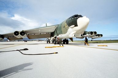 Ground crew members chock the wheels of a 28th Bomb Wing B-52 Stratofortress aircraft just after its arrival during Exercise Glad Customer '82