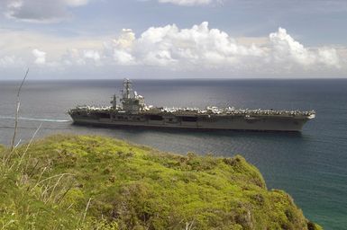 The US Navy (USN) Aircraft Carrier USS NIMITZ (CVN 68) underway near Orote Point, which marks the entrance to Apra Harbor, Guam (GU). The Nimitz Carrier Strike Group is visiting Naval Base Guam (GU) for a scheduled port visit and is on a regularly scheduled deployment in support of the Global War on Terrorism