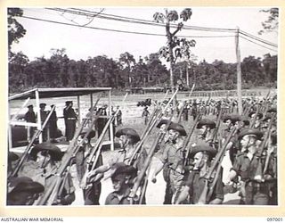 TOROKINA, BOUGAINVILLE. 1945-09-24. TROOPS OF 57/60 INFANTRY BATTALION, 15 INFANTRY BRIGADE, MARCHING WITH FIXED BAYONETS AS THEY PASS THE SALUTING BASE DURING THE MARCH PAST AT A PARADE HELD AT ..