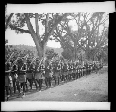 Police marching along Malaguna Road, Rabaul, New Guinea, ca. 1936 / Sarah Chinnery