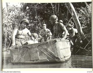 1943-07-31. ALLIED CAPTURE OF MUBO. AMERICAN INFANTRY ABOUT TO CROSS A CREEK EN ROUTE TO THE FRONT LINE. FROM NASSAU BAY THE AMERICANS AND AUSTRALIANS WENT FORWARD TO CAPTURE MUBO. (NEGATIVE BY G. ..