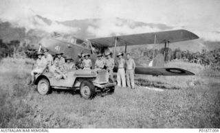 Kokoda, New Guinea. 1943-02. Informal group portrait of members of No. 33 Squadron RAAF in front of a De Havilland Dragon aircraft (41) flown by Sergeant Frank Leslie Boyd Craig. They were ..